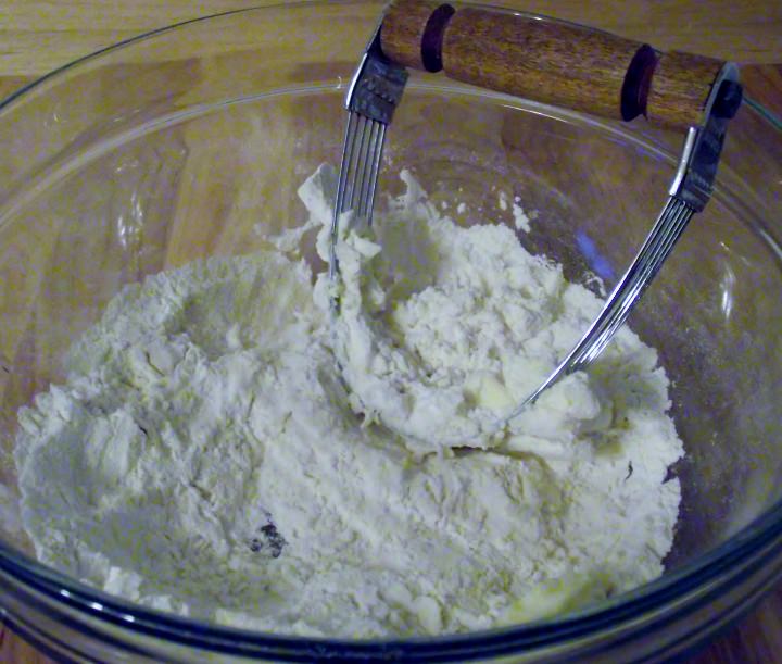 Cutting the butter into the flour mixture.