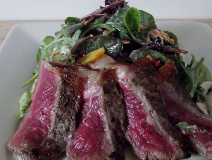 Seared rare NY steak salad.