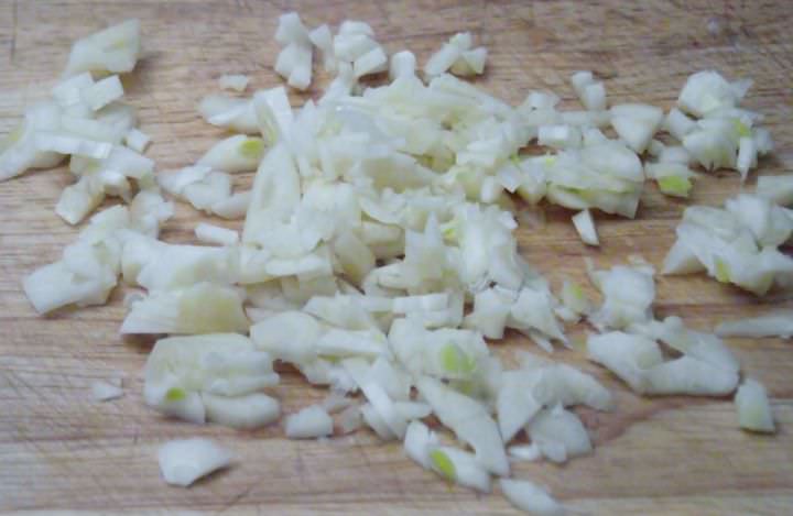 Chopped garlic on a cutting board.