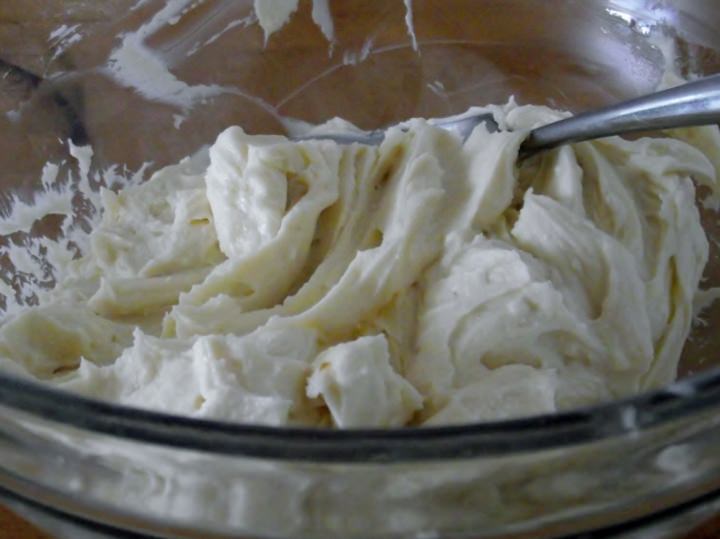 Mixing cannoli cream in a bowl.