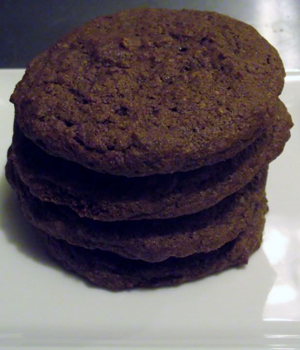 Chocolate cookies stacked on a plate.