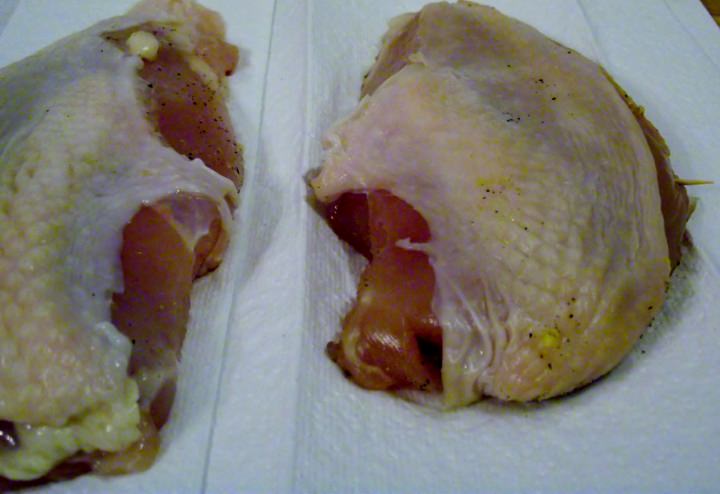 The chicken breasts ready to cook. The breast on the left has been brined. The breast on the right, with the pick through it, has been cured.