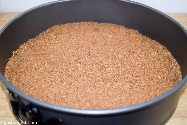 Graham cracker crust in a springform pan.