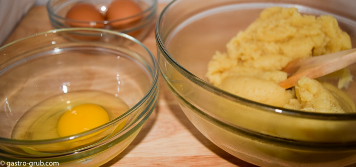 Adding eggs to the pastry dough.