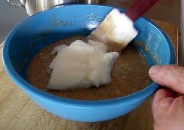 Folding egg whites into waffle batter.