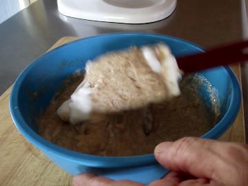 Folding egg whites into waffle batter.