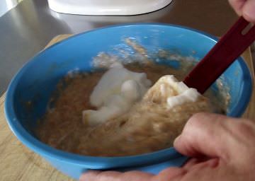 Folding egg whites into waffle batter.