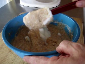 Folding egg whites into waffle batter.