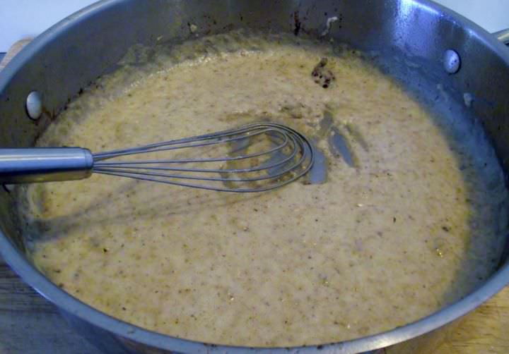 Chicken gravy in a pan.