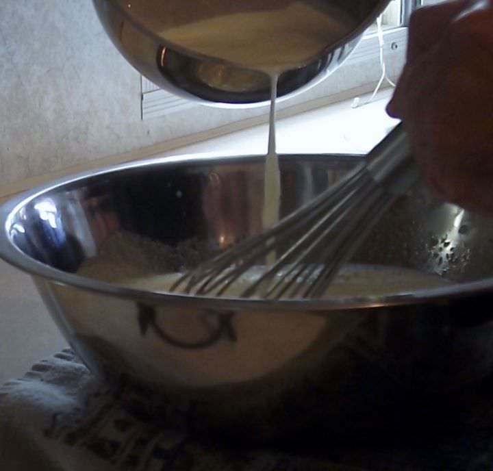 Tempering the egg yolk mixture.