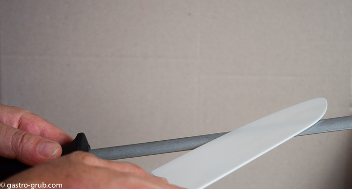 Sharpening a ceramic knife with a diamond steel.