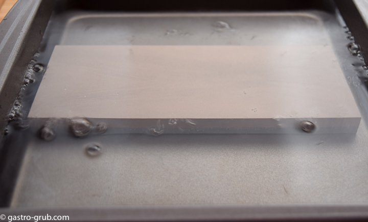 Soaking whetstones in a water bath.