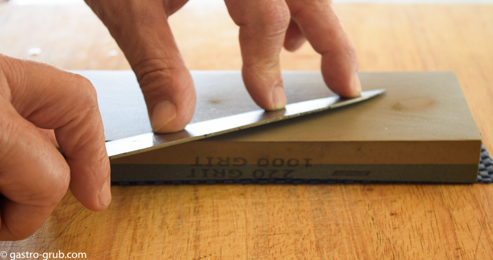 Sharpening a knife on a whetstone.