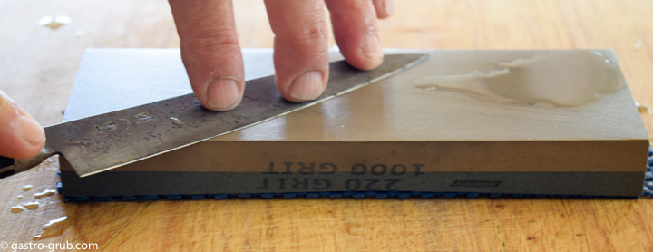 Sharpening a knife on a whetstone.