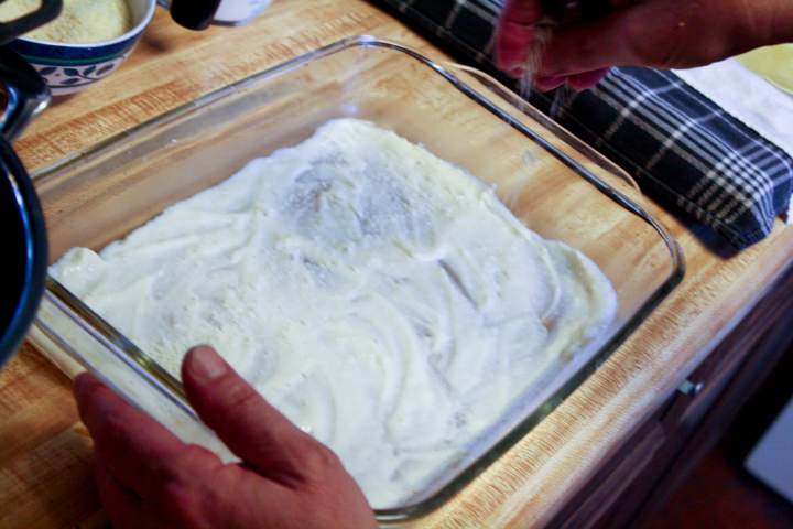 A 9 x 13 baking dish spread with bechamel.