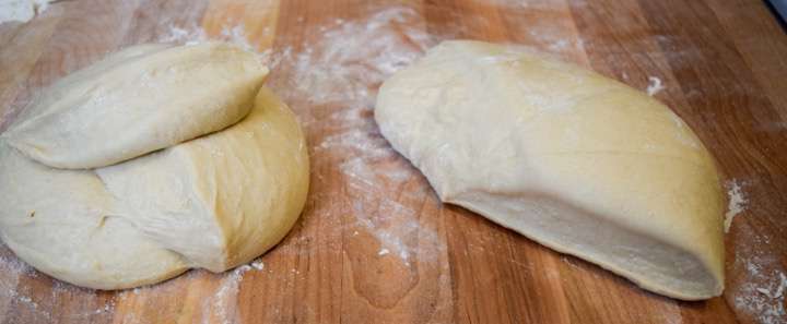 Bread dough on a pastry board, divided.