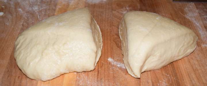 Bread dough on a pastry board, divided.