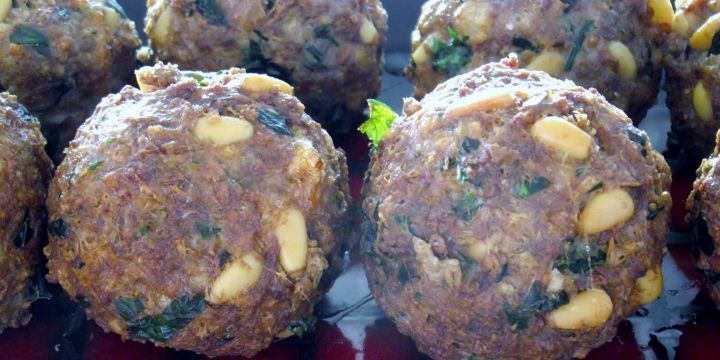 Meatballs resting on a plate.