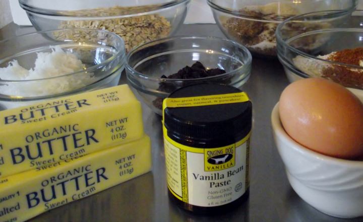 Ingredients for oatmeal raisin cookies: oats, sugar, flour, soda, salt, cinnamon, raisins, coconut, butter, vanilla, and eggs.