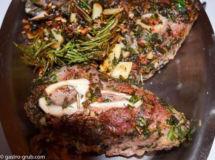 Browned lamb shanks resting on a platter.