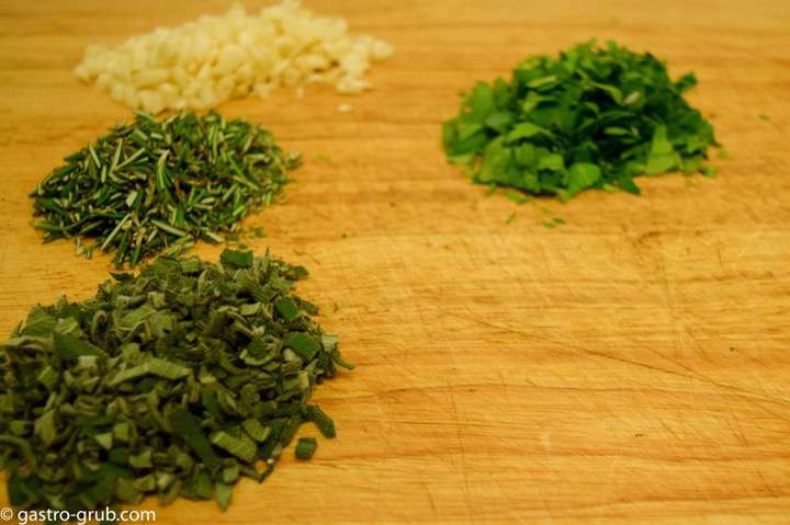 Chopped herbs on a cutting board.