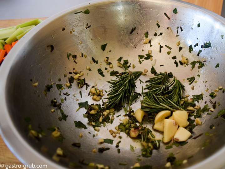 After adding the lamb shanks to the pot I am using the garlic and rosemary to scrape out the bowl, into the pot with the lamb shanks.