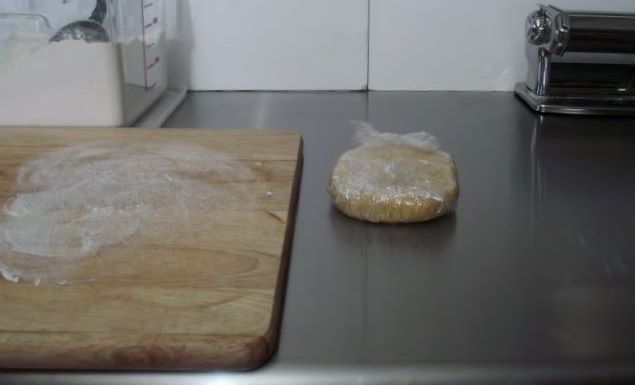 Homemade pasta resting in plastic wrap.