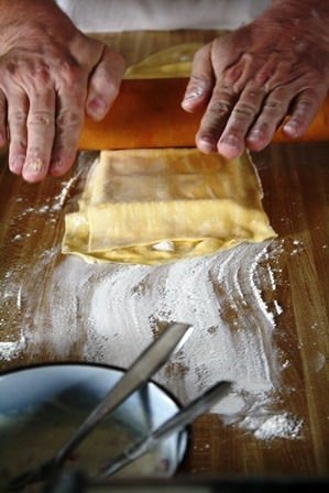 Cutting raviolis with a rolling pin.