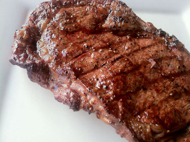 Grilled rib eye steak showing the grill marks.