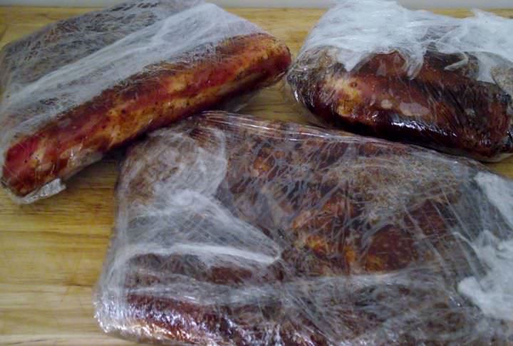 Rib sections coated with dry rub and double wrapped in food grade film.