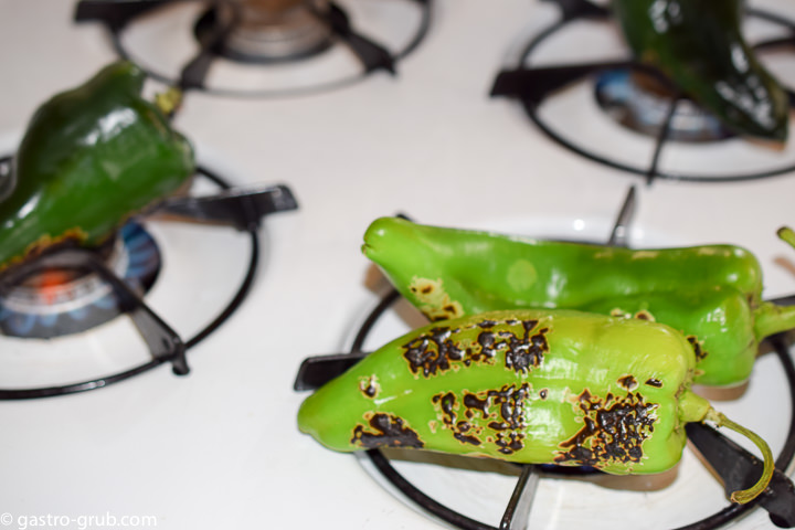 Blackening chilies over kitchen burners.