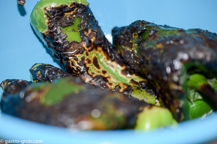 Blackened chilies resting in a bowl.