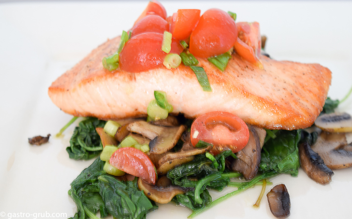 Seared salmon, sautéed mushrooms, and wilted kale with a cherry tomato relish.