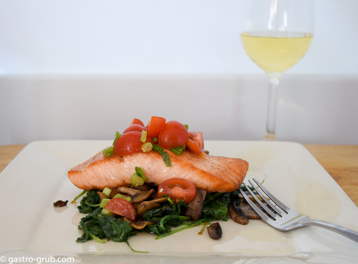 Seared salmon, sautéed mushrooms, and wilted kale with a cherry tomato relish.