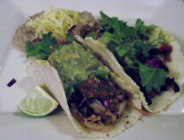 Pulled pork tacos with cabbage, cilantro salsa and guacamole on homemade tortillas.