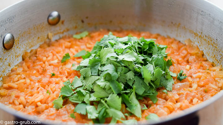 Spanish rice in a pot, topped with cilantro.