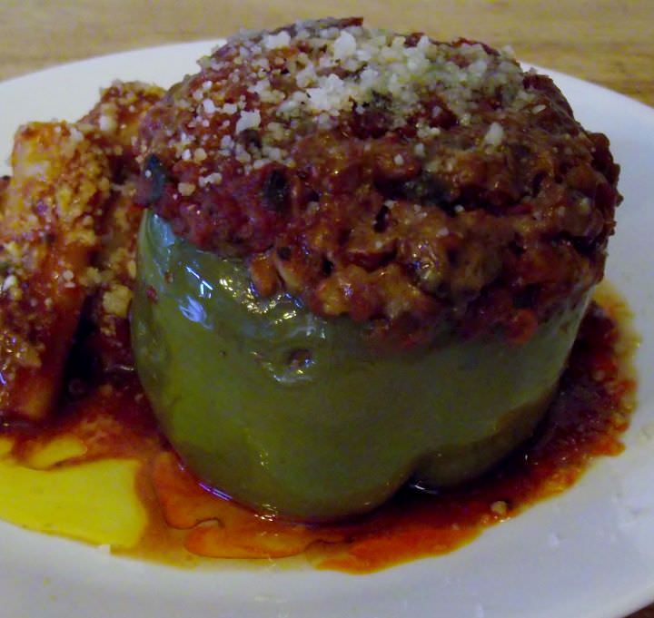 Stuffed bell pepper and pasta on a plate.