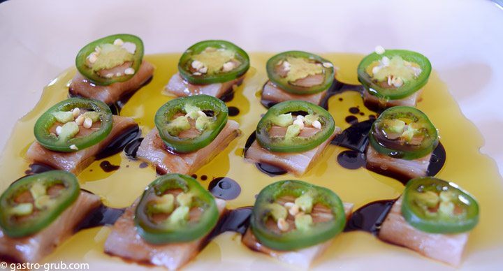 Mahi mahi sashimi with jalapeno peppers, olive oil and soy sauce.