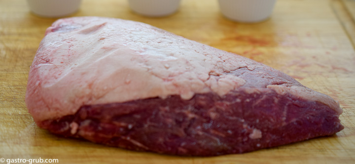 Tri tip on a cutting board showing the fat cap.