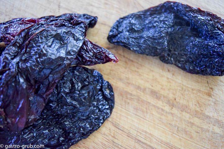 Ancho chilies on a cutting board.