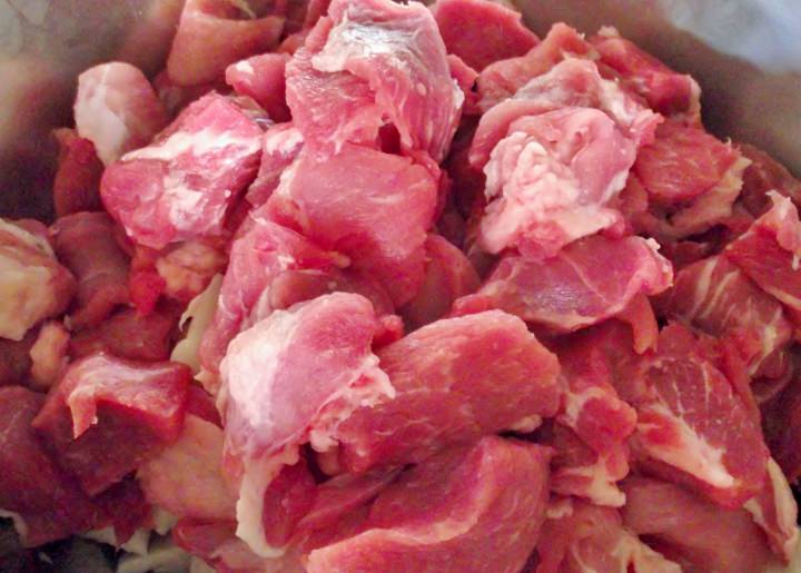 The meat and fat are cut into small chunks for the grinder.