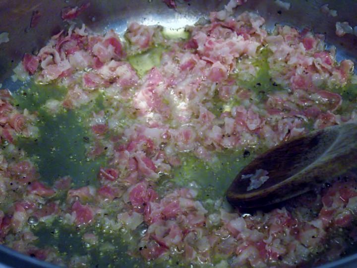 Frying pancetta in olive oil.