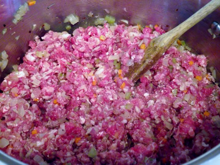 Adding the beef and pork to the vegetable pancetta mixture.