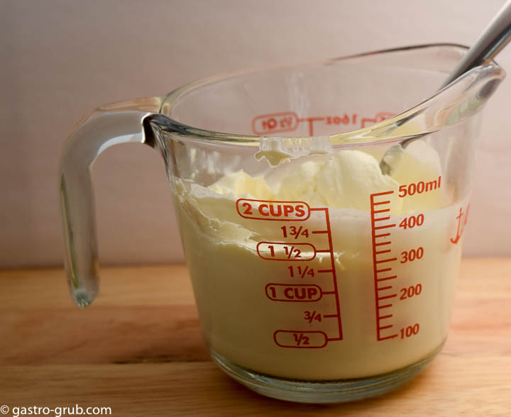 Mexican crema in a measuring cup.