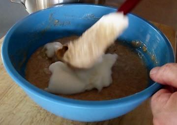 Folding egg whites into waffle batter.