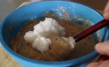 Folding egg whites into waffle batter.