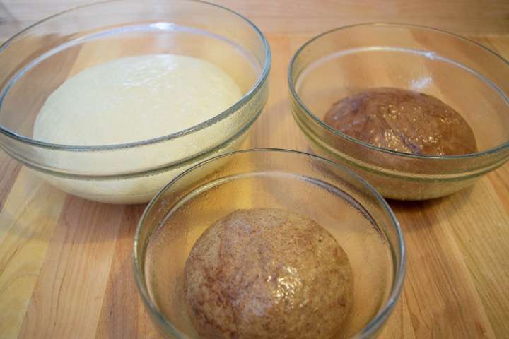 Plain dough, cinnamon dough, and cocoa dough rising in glass bowls.