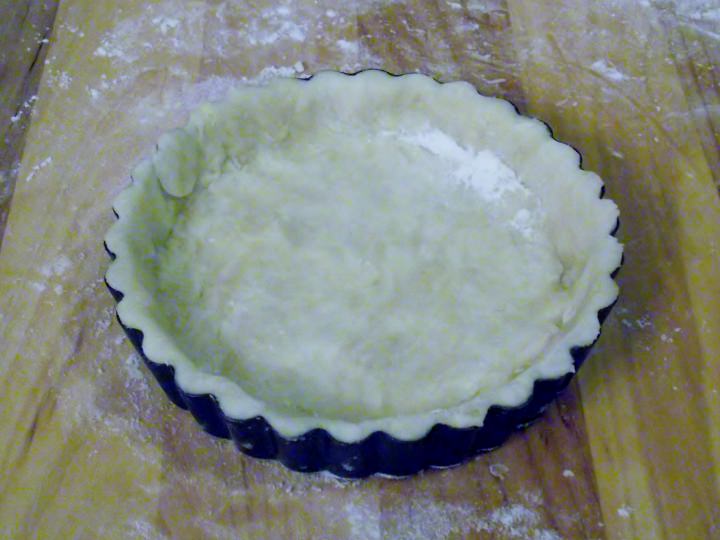 Pastry crust lining an individual tart pan.