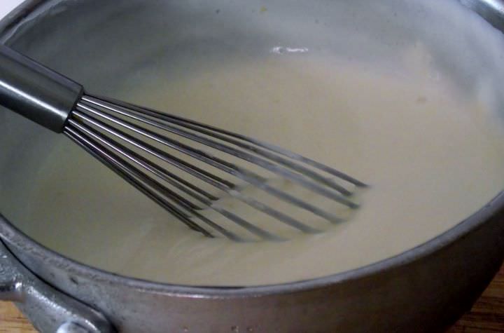 Adding the whipped cream to the milk mixture.