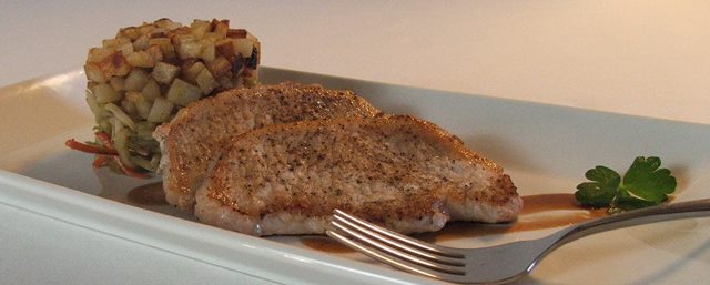 Seared pork chops with stacked broccoli slaw and fried potatoes.